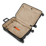 Briggs & Riley Torq medium spinner suitcase in stealth black with four wheels and a sturdy handle, designed for easy travel.