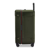 Briggs & Riley Torq medium trunk spinner in stealth black with four wheels and a sturdy telescopic handle for easy rolling.