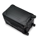 Briggs & Riley Torq medium black trunk spinner with four wheels and sturdy handles for easy travel and mobility.