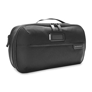 Briggs & Riley Baseline expandable toiletry kit with multiple compartments and zipper closure, designed for travel organization.