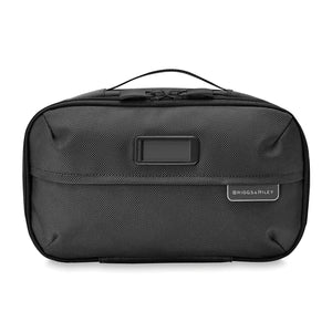 Briggs & Riley Baseline expandable toiletry kit with multiple compartments and zipper closure for organized travel essentials.