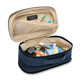Briggs & Riley Baseline expandable toiletry kit with multiple compartments and sleek design for travel organization.