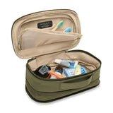Briggs & Riley Baseline expandable toiletry kit with multiple compartments and zipper closure, designed for organized travel essentials.