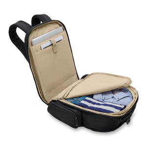Briggs & Riley Baseline Traveler Backpack with multiple compartments and padded shoulder straps, designed for travel ease.