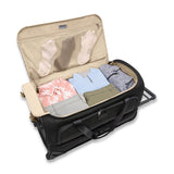 Briggs & Riley Baseline medium two-wheel duffle bag in blue, featuring a wheeled design with sturdy handles and spacious interior.