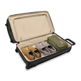 Briggs & Riley Baseline medium two-wheel duffle bag in blue with padded handles and zipper closure, designed for travel convenience.