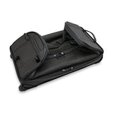 Briggs & Riley Baseline medium two-wheel duffle bag in blue fabric with rolling wheels and handle for travel.