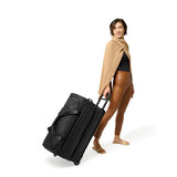 Briggs & Riley Baseline medium two-wheel duffle bag in blue with a sturdy handle and wheels, designed for travel and easy carrying.