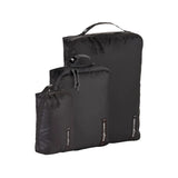 Eagle Creek PACK-IT™ Isolate Cube Set XS, S, and M for organizing clothes and accessories in luggage, shown in black.