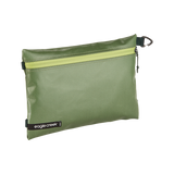 Eagle Creek PACK-IT™ Gear Pouch M used for packing organization, shown open with compartments and accessories inside.