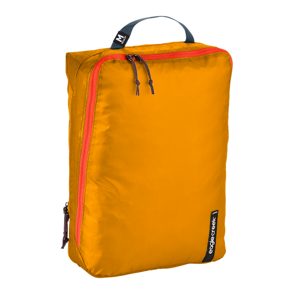 Eagle Creek PACK-IT™ Isolate Clean and Dirty Cube M for packing organization, showing a compact, organized travel cube with compartments.