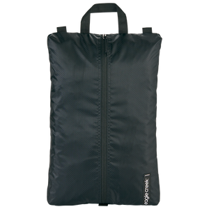 Eagle Creek PACK-IT™ Isolate Shoe Sac for packing organization, showing a black zippered shoe bag with logo detail.