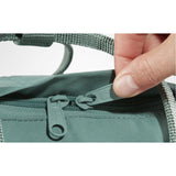 Fjallraven Kanken backpack in frost green with top handle, front zipper pocket, and adjustable shoulder straps.