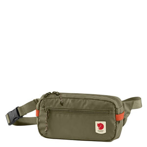 Green Fjallraven High Coast Hip Pack worn around the waist, showcasing its compact, functional design for outdoor activities.