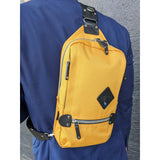 Harvest Label sling pack with adjustable strap and multiple compartments, shown in black fabric on a plain background.