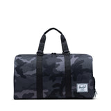 Herschel Novel Duffle bag in black with leather accents, featuring adjustable shoulder strap and spacious main compartment.