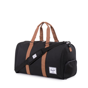 Herschel Novel Duffle bag in black with twin handles and a spacious main compartment, suitable for travel or gym use.