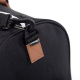 Herschel Novel Duffle bag in black with leather accents, featuring a spacious main compartment and sturdy carry handles.