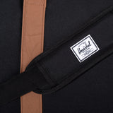 Black Herschel Novel Duffle bag with sturdy handles and spacious main compartment, shown on a plain background.