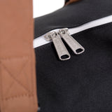 Herschel Novel black duffle bag with sturdy handles and zipper closure, featuring a sleek, minimalist design.