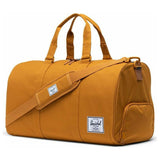 Herschel Novel Duffle bag in black with leather accents, featuring adjustable shoulder strap and main zippered compartment.