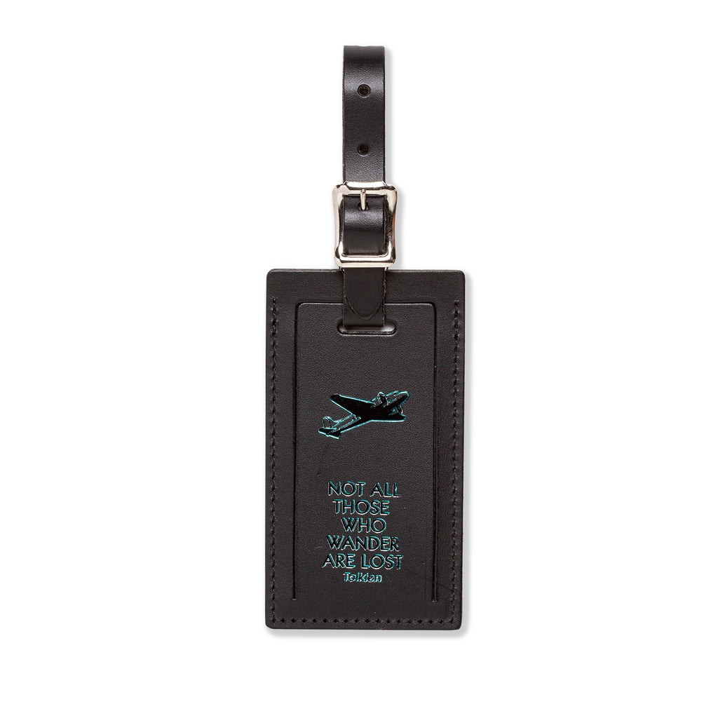 Index Urban luggage tag featuring a plane design with the phrase "Not All Those Who Wander Are Lost" for travel accessories.