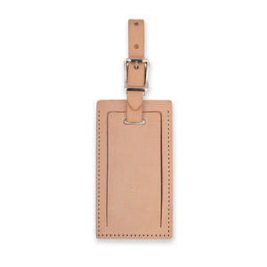 Tan personalized leather luggage tag by Index Urban featuring a clear ID window and durable leather strap.