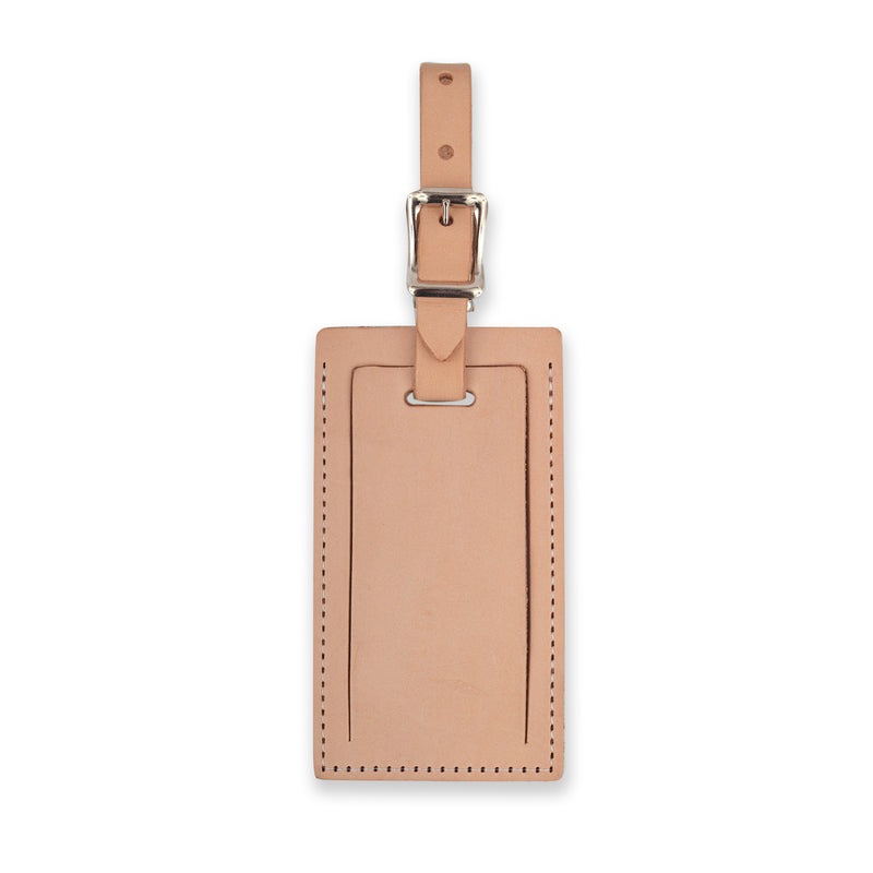 Tan personalized leather luggage tag by Index Urban featuring a clear ID window and durable leather strap.