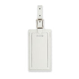 White personalized leather luggage tag by Index Urban, made in the USA, with adjustable strap and clear identification window.