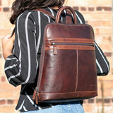 Jack Georges Voyager Adele Slim Backpack in brown leather, featuring sleek design, adjustable straps, and multiple compartments.