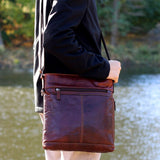 Brown Jack Georges Voyager crossbody bag with adjustable strap and multiple compartments for stylish, hands-free carrying.