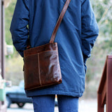Brown Jack Georges Voyager small zippered crossbody bag with adjustable strap and sleek design, perfect for everyday use.