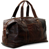 Jack Georges Voyager Duffle Bag in brown leather with handles and adjustable shoulder strap, showing its spacious design.
