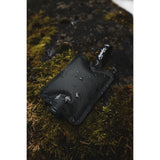 Set of three charcoal Matador FlatPak™ Toiletry Bottles, compact travel accessories for toiletries and liquids.