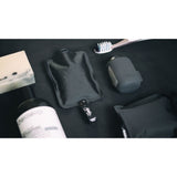 Set of three charcoal Matador FlatPak™ toiletry bottles, compact travel accessories for liquids and toiletries.