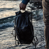Matador Freefly16 packable backpack shown folded and partially unfolded, lightweight and compact travel and everyday backpack