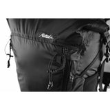 Matador Freerain22 waterproof packable backpack in black, shown folded and partially unfolded, with adjustable straps and compact design.