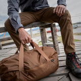 Matador Transit30 duffle bag in Coyote color with durable fabric and compact design, shown in a lifestyle setting.