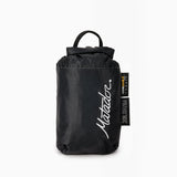 Matador Transit30 duffle bag in charcoal, shown packed and ready for travel. Compact, durable, and stylish travel gear.