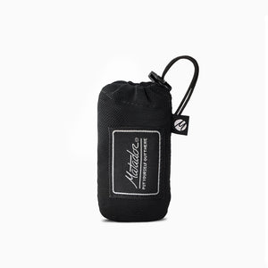 Matador Mini Pocket Blanket in black, compact and folded for travel, part of Matador's travel essentials collection.