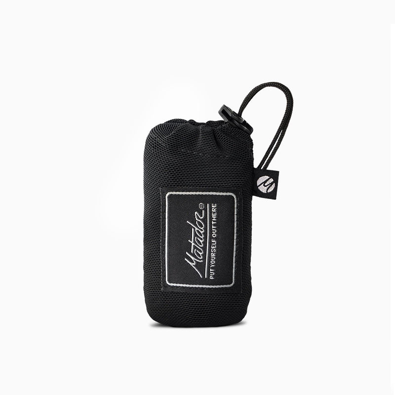 Matador Mini Pocket Blanket in black, a compact travel essential made of durable fabric, perfect for outdoor and on-the-go use.