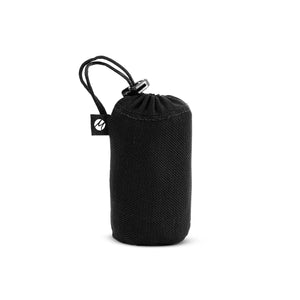 Matador mini pocket travel blanket in white, folded with its compact design and portable size displayed.