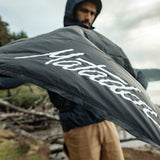 Black Matador Mini Pocket Blanket, a compact travel essential for outdoor picnics and outdoor adventures.