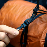 Matador Better Tether™ Gear Straps 2-Pack used to secure gear during travel, shown in outdoor setting with backpacks and travel gear.