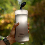 Matador packable water bottle made of lightweight, durable material, shown folded and expanded for easy hydration on the go.