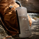 Matador packable water bottle made of durable material, shown folded and expanded for easy hydration on outdoor adventures.