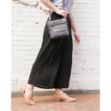 Black Osgoode Marley Small Crossbody Traveler bag with adjustable strap and compact design for convenient everyday use.
