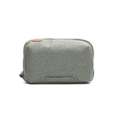 Peak Design Tech Pouch in hero sage color, showing its compact, organized design with multiple zip compartments and sleek fabric exterior.