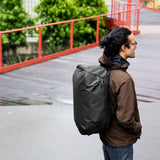 Black Peak Design Travel Duffel 35L bag with sturdy handles and zipper closure, designed for versatile travel storage.