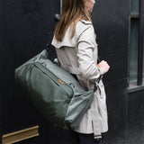 Peak Design Travel Duffel 35L in sage green, showing the spacious, durable fabric and adjustable shoulder strap on a plain background.